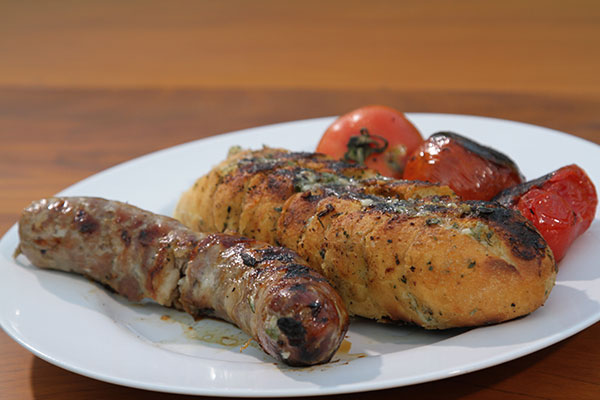 Linguiça temperada suína com pão de alho e tomate tostado da Kalie
