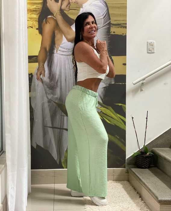 Grtechen posa usando cropped branco e calça pantalona verde