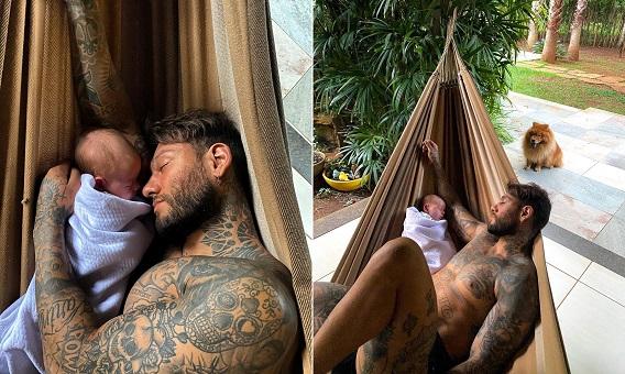 Foto mostra Lucas Lucco e o bebê Luca deitados em uma rede com os olhos fechados