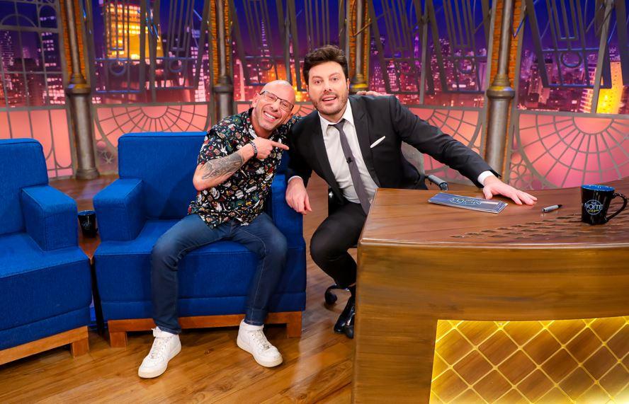 Rafael Ilha e Danilo Gentili posam para foto no palco do programa.