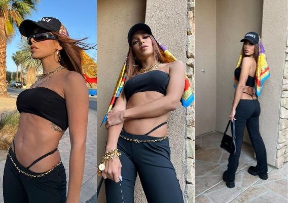 Anitta posa usando calça, top, boné e lenço na cabeça