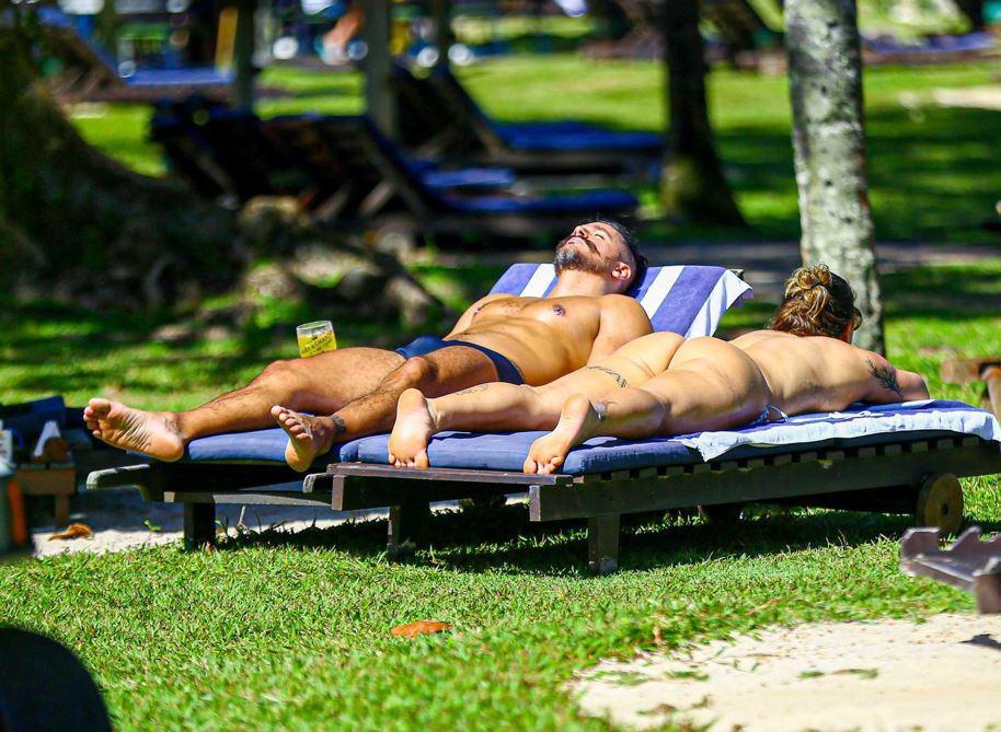 Priscila Fantin e Bruno Lopes tomando sol em cadeira de praia.