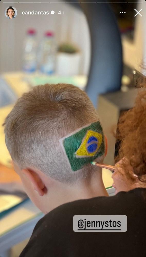 davi lucca de costas mostrando a cabeça com uma bandeira do brasil pintada no cabelo