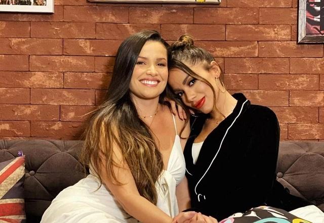 Juliette e Anitta se abraçam e posam para a foto sentadas em um sofá